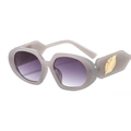 Fashionable tea-colored sunglasses with oval frame and golden leaf temple accents - Grey Frame Grey Lens