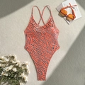 Detail of orange zebra print swimsuit with thin straps and gold foil on fabric texture - S / Orange Red