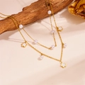 Double-layered golden necklace with white pearls and clover pendants on a rustic background - Five-leaf Flower Style (D313)