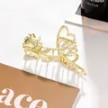 Detailed view of elegant gold metal rose and heart shaped hair claw clip on leather - Metallic Rose-Solid Gold