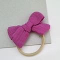 Purple muslin bow headband for babies with soft beige nylon elastic band on grey board - Purplish Red