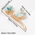 Golden alloy shark hair claw clip featuring blue-green dragonfly and lotus design - HS02634 Blue