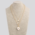Detail of layered gold-tone necklace with white spiral conch shell and round pearl charms - NZ421-X-Gold Shell
