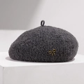 Detailed texture of dark grey wool beret featuring a delicate golden bow metal buckle - Adjustable / Gray