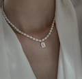 Detail of rice pearl necklace with emerald-cut zircon pendant on white silk shirt - Single Layer Pearl Chain (Square Pendant - Natural Growth Lines)