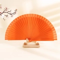 Classic orange solid wood folding fan on wooden stand with elegant floral decoration - Orange