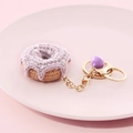Handmade crochet beige and purple donut keychain with golden chain on pink plate - Donut-Purple