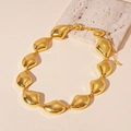 Dettaglio della collana a catena dorata con elementi in metallo fluido e chiusura a moschettone - Oro
