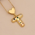 Close-up of golden heart pendant with letter T featuring vibrant colorful zircons - Letter T / Gold