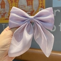 Large lilac bow hair clip made of shimmering fabric held in hand for women - Mermaid Shimmer Lt Purple