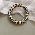 Detailed macro of acrylic leopard print tube bracelet with golden metallic spacer beads - Pink Black Leopard (Bracelet-Pink-Black)