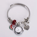 Macro shot of silver quartz watch bracelet with red watermelon and heart charms - Red Watermelon Style
