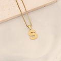 Golden letter S pendant necklace with textured finish on a minimalist stone setting - S