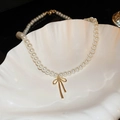 Delicate pearl necklace featuring a gold bow pendant and elegant tassel accents - White with Bowknot