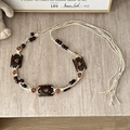 Detail of bohemian hand-woven waist belt with wooden beads and carved rose floral charms - Heart Cookie Coconut Rose Beige - 171cm