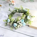 Floral crown with blue roses, white flowers, and green leaves featuring white silk ribbons - Blue White Rose Combo