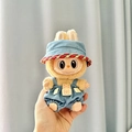 Plush doll outfit featuring a yellow fur suit and blue denim overall set with hat - Blue And Red Trimmed Cowboy Hat + Happy Cowboy Bear Keychain / First And Second Generation Keychains Are Compatible With La Cloth Dolls. Dolls Not Included.