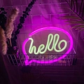Close-up of pink and yellow LED hello neon sign in a white basket for room decor - 1-2W / Hello Bubble Pink White