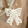 Detail of white glitter bow ornament with silver hanging string for Christmas trees - Bow
