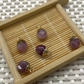 Faceted pink purple natural stone pendants with gold metal edging on a bamboo tray - No.20 Pale Purple Stone