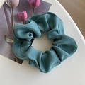 Elegant emerald green satin scrunchie with silky luster texture on white tabletop - 15# Emerald Green