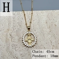 Macro shot of 18mm golden Virgin Mary pendant with sparkling white cubic zirconia stones - H-Virgin Mary Relief