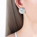 Silver fan earrings with shell texture and blue opal gemstone on a model ear - Moonstone (Silver Tone)