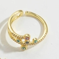 Detailed shot of golden cross ring with colorful enamel eye and zircon inlay - Colorful Enamel
