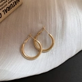 Detail of minimalist gold hoop earrings with sparkling diamonds on a white fabric background - 25mm Gold Shiny Round Hoop Style (98#)