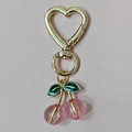 Detail of pink resin cherry pendant with green enamel leaves and golden heart clip - Gold Heart Hook Pink Cherry (Two Leaves)