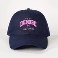 Detail of navy baseball cap featuring pink Very Demure print and bow embroidery - Adjustable / Navy Blue