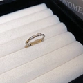 Detail of silver bamboo style ring with cubic zirconia stones on white fabric - Silver