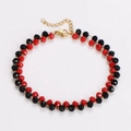 Detail of beaded bracelet featuring faceted black and red beads with adjustable gold clasp - Black Red