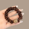 Dark brown satin scrunchie with a gold rhinestone bead detail held in hand - Dark Coffee Rhinestone Scrunchie