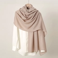 Close-up of soft beige linen texture on a solid color women's scarf draped on a hanger - Khaki