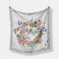 Macro shot of vintage astronomical silk scarf showing lunar patterns and floral details - Beige