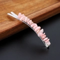 Macro shot of pink natural crystal stones on a silver metal hair clip with wooden background - Pink Opal with Silver Clip