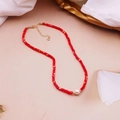 Detailed shot of red seed bead necklace featuring a central white pearl and gold clasp - Red Shell Freshwater Pearl Necklace