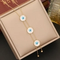Golden stainless steel evil eye bracelet with white shell inlays on a jewelry box - Evil Eye Necklace (1# Necklace)