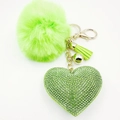 Close-up of green faux fur pompom keychain with rhinestone heart and golden tassel - Light Green