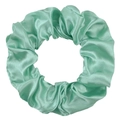 Detail of mint green satin scrunchie showing smooth silky texture and elastic folds - Cyan