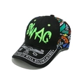 Close-up of Swag graffiti embroidery and skeletal graphics on a street style baseball cap - Black and Green (C)