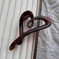 Detail of dark brown tortoiseshell heart claw clip on beige corduroy and paper - Matte Tortoise
