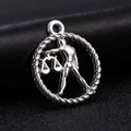 Detailed view of a silver Libra zodiac pendant with textured rope border and central scales motif - Style 11 / Antique Silver