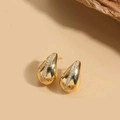 Macro shot of gold teardrop earrings featuring a centered row of white zircon accents - 14K Gold Plated Small Waterdrop