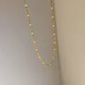 Golden chain necklace with small lemon yellow bead accents in a minimalist style - Yellow Enamel Style (D1152)