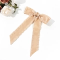 Detail of champagne satin bow hair clip with ruffled edges and long flowing ribbons - Khaki