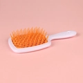 Hollow grid hair brush in white and orange for styling and detangling hair - White Handle + Orange