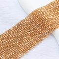 Macro shot of 2mm golden faceted crystal beads for DIY handmade jewelry crafting - 2mm (Approx. 210 Beads per Strand) / Amber (Gold Champagne)