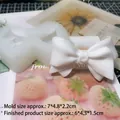 White silicone bow mold for scented plaster casting with finished product examples - Clear